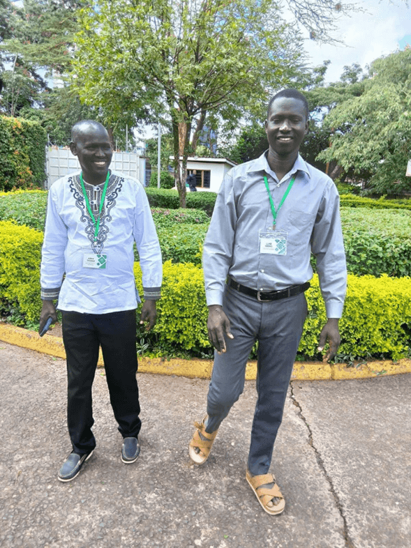 Two pastors smiling while wearing conference name tags.
